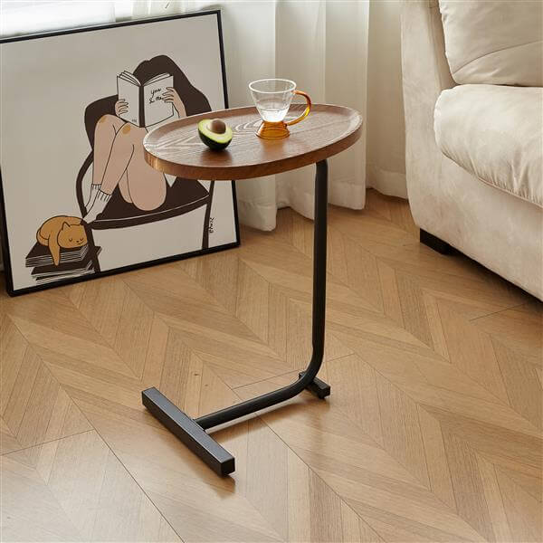 C shaped side table sliding under sofa in living room lifestyle photo