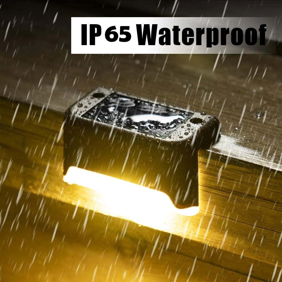 IP65 waterproof solar deck light emitting warm white glow on wooden deck in rain