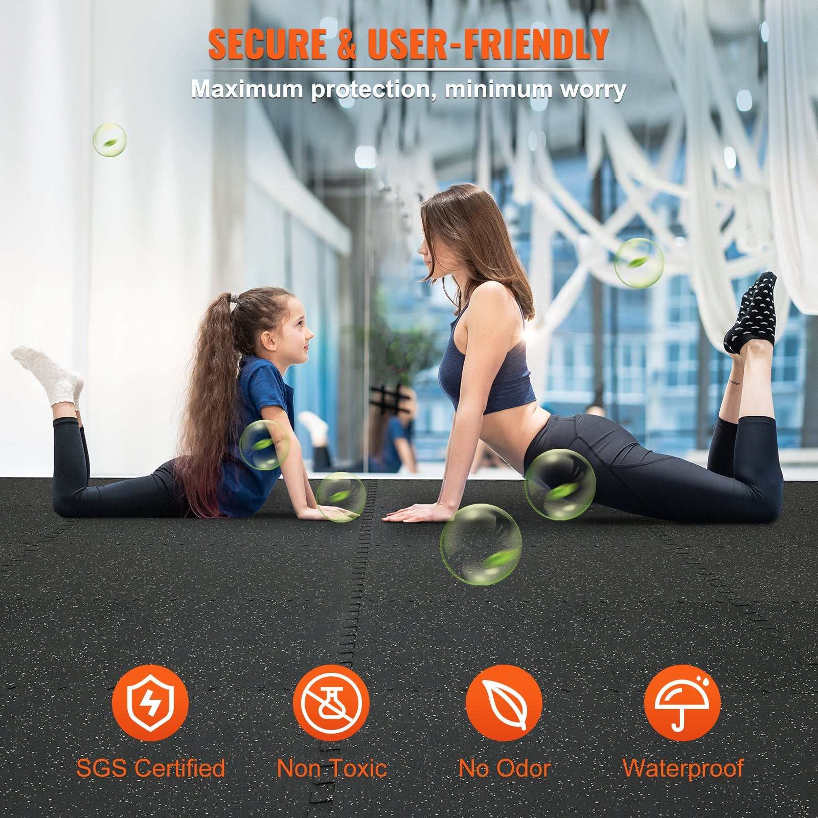 Two women doing yoga on black interlocking gym floor mats in a bright exercise space