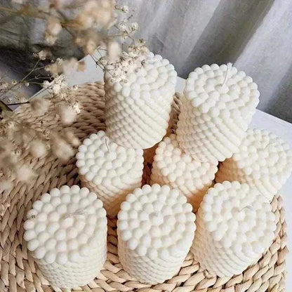 Set of round 3D bubble candles in creamy white, arranged on a woven tray with dried flowers.