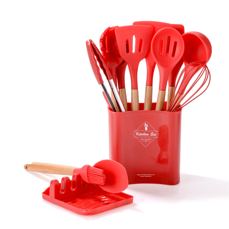 12-piece silicone kitchen tool set with wooden handles in red including spatulas, tongs, and whisk.