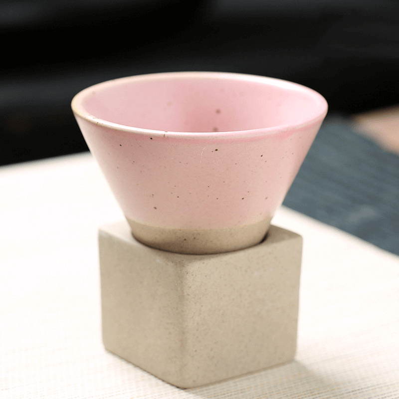 Japanese retro ceramic coffee cup in pink, features a unique cone shape and sits on a square base, perfect for enjoying your favorite beverages.