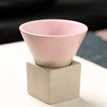 Japanese retro ceramic coffee cup in pink, features a unique cone shape and sits on a square base, perfect for enjoying your favorite beverages.
