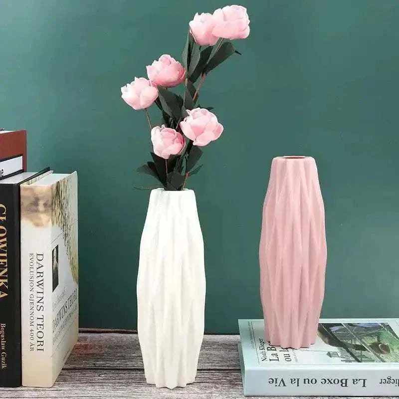 Diamond Pattern Faux Ceramic Vase in pink and white with textured diamond design holding pink flowers on wooden surface with books nearby