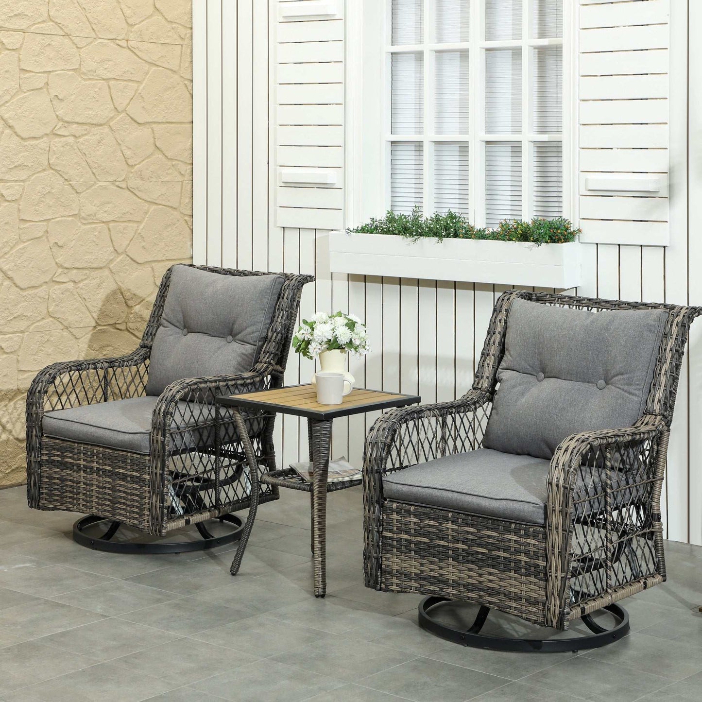 Coastal Comfort Wicker Swivel Bistro Set with two gray cushioned swivel chairs and a small two-tier table on patio