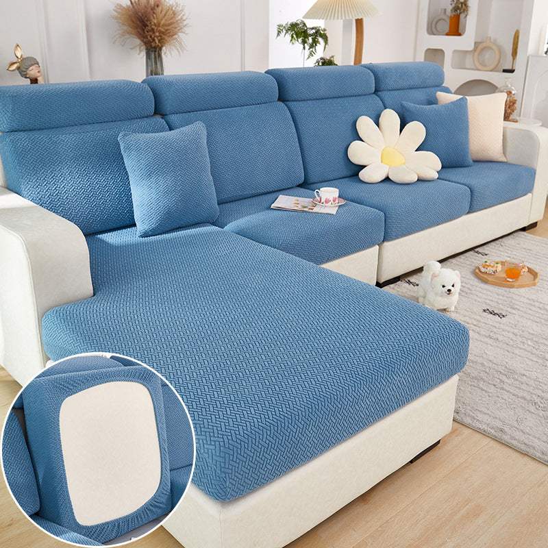 West Lake Blue knitted all-season elastic sofa slipcover fitted on sectional sofa with cushions and flower pillow