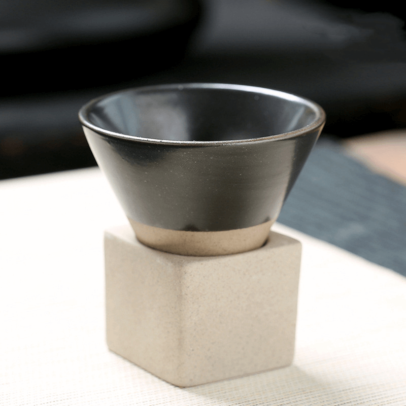 Japanese retro ceramic coffee cup with a textured square holder, featuring a stylish black interior and beige base.