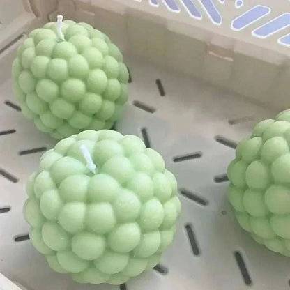 Round green bubble candles made with silicone molds, showcasing a unique 3D design.