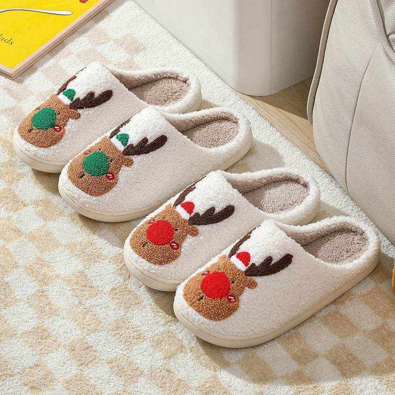 Pair of cozy elk winter home slippers with plush lining and antler motif in red and green colors