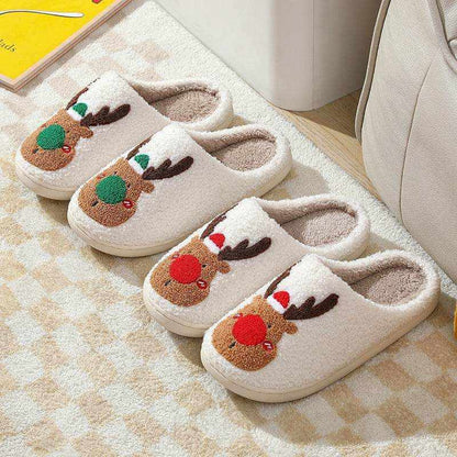 Pair of cozy elk winter home slippers with plush lining and antler motif in red and green colors