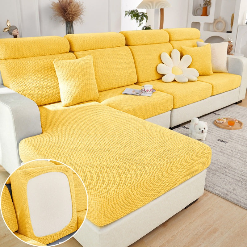 Yellow elastic sofa slipcover with textured knit on sectional sofa in modern living room