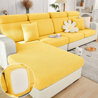 Yellow elastic sofa slipcover with textured knit on sectional sofa in modern living room