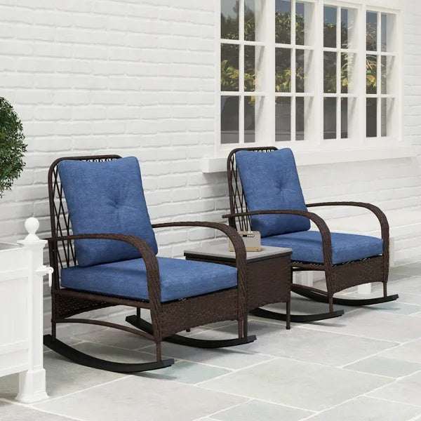 Rattan Chaise Lounge Chair and side table set with blue cushions on a patio area.