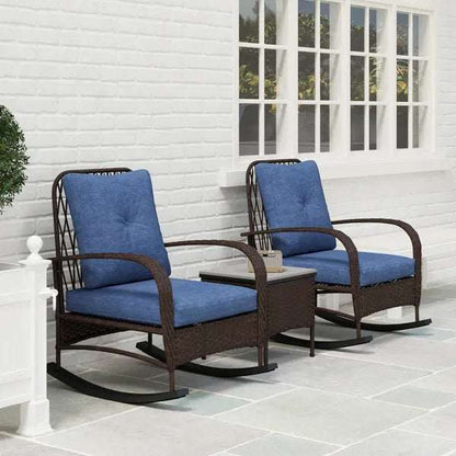 Rattan Chaise Lounge Chair and side table set with blue cushions on a patio area.