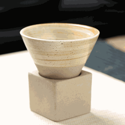 Japanese retro ceramic coffee cup with natural swirling design on a beige square base.