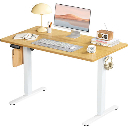 Ergonomic Height Adjustable Table with a wooden top, keyboard, lamp, and monitor setup for a modern workspace.