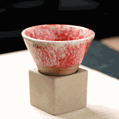 Japanese Retro Ceramic Coffee Cup with red speckled design, displayed on a square beige base.