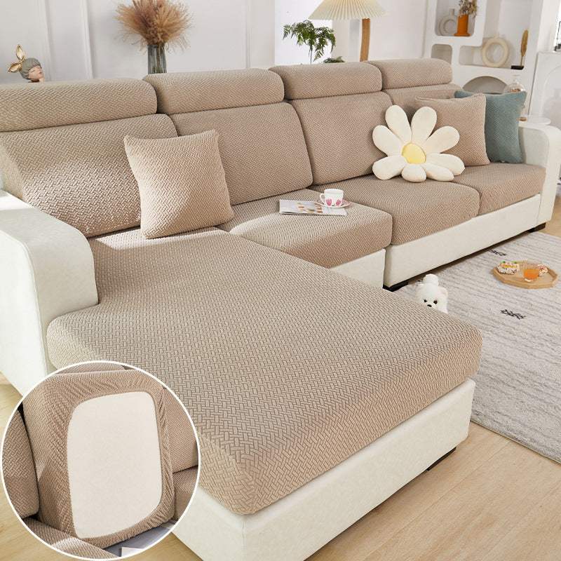modern all-season elastic sofa slipcover in beige knitted fabric on sectional couch with matching pillow and daisy cushion in living room