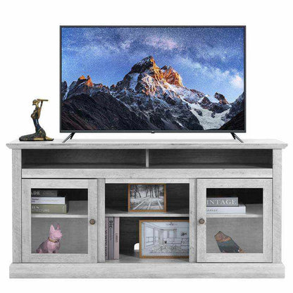 Chic wooden TV stand in gray with storage, featuring decorative items and a TV displaying a mountain landscape.