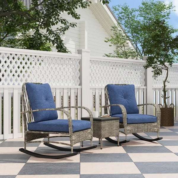 Cozy outdoor setup with Rattan Chaise Lounge Chair set and blue cushions on a patio with lattice fence and trees.