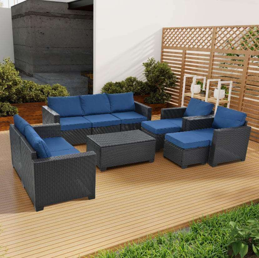 Cozy outdoor patio set 10-piece modular seating with dark wicker frame and blue cushions on wooden deck.