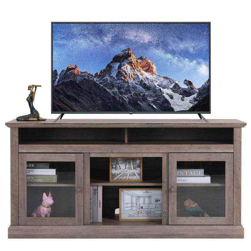 Chic wooden TV stand in gray with glass cabinets, stylishly displaying a TV and decorative items.