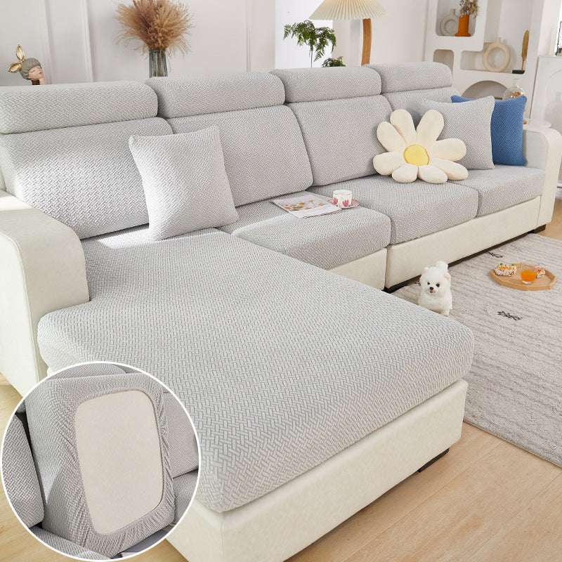grey elastic sofa slipcover fitting a modern sectional couch with textured knit fabric