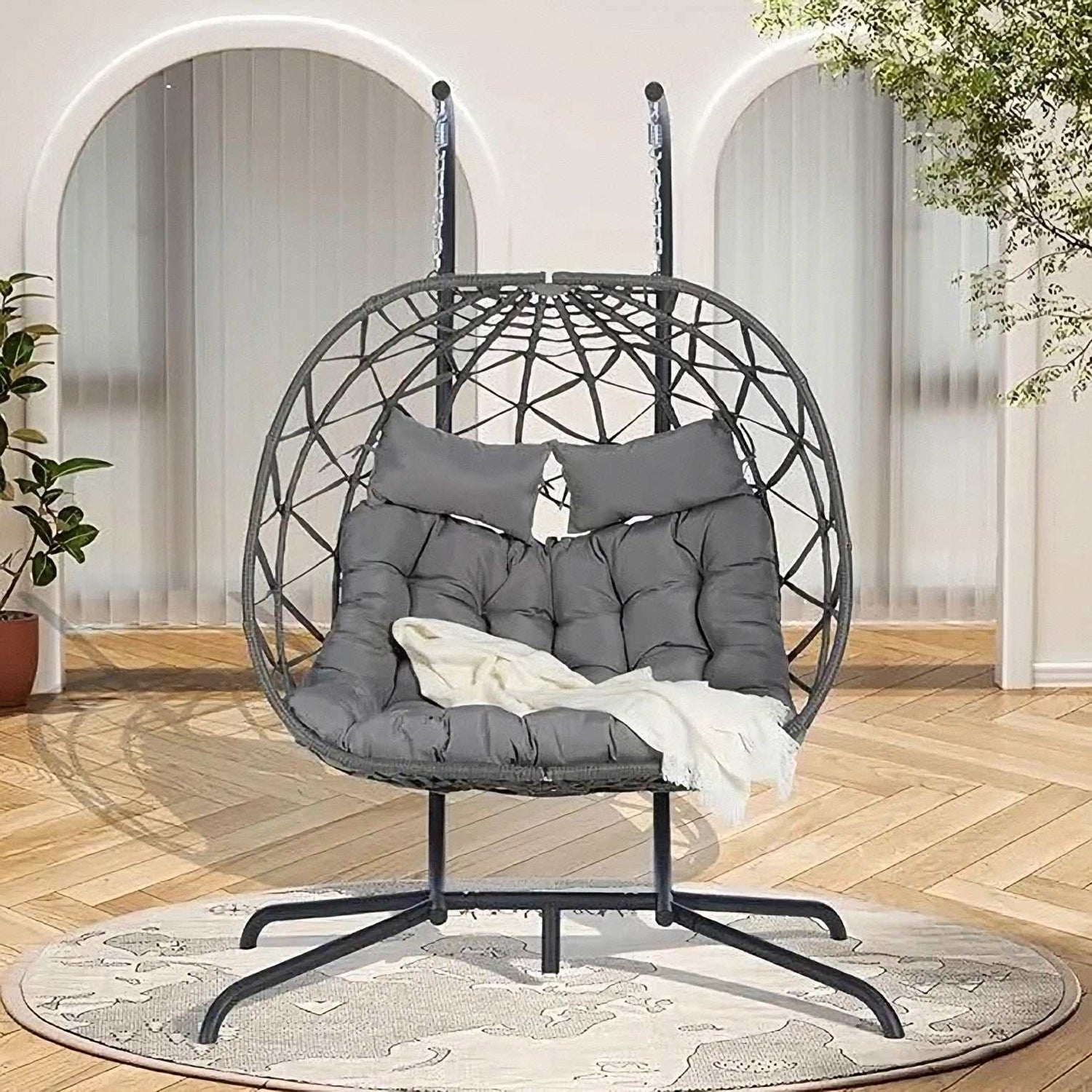 Two person hanging egg chair with metal frame and grey cushions, indoor/outdoor double swing seat