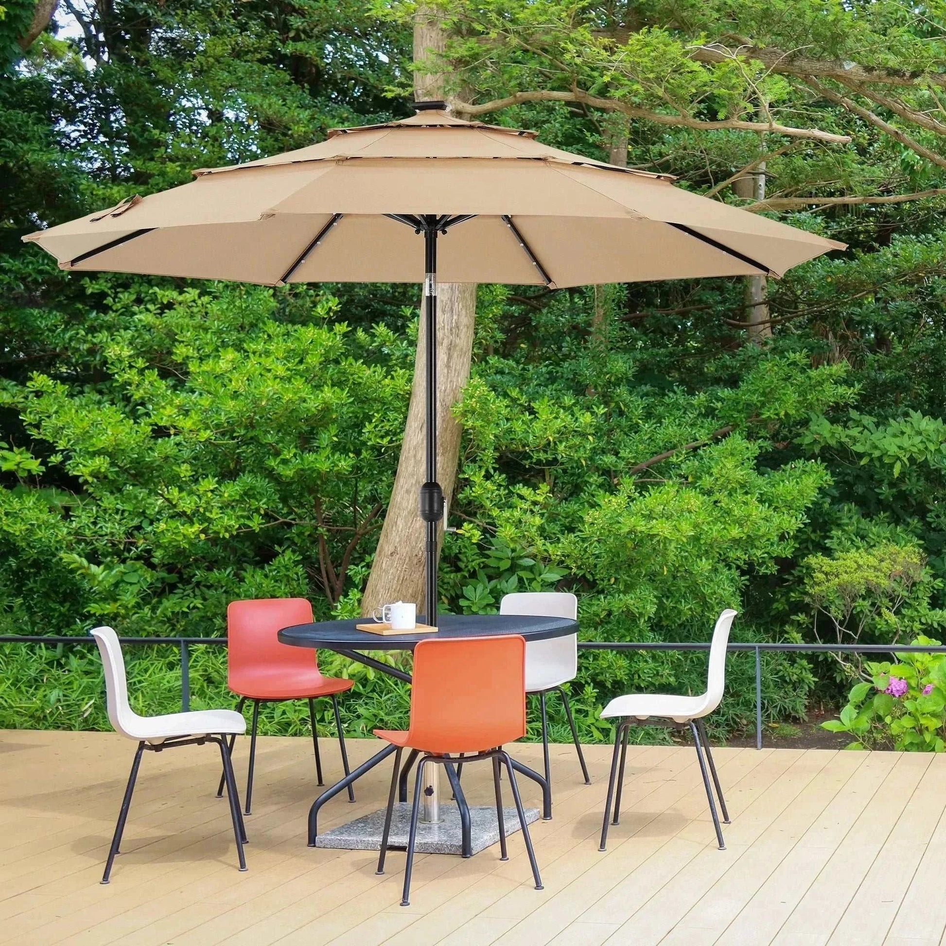 Patio Umbrella Solar Glow with LED beige umbrella providing shade over outdoor dining set surrounded by greenery