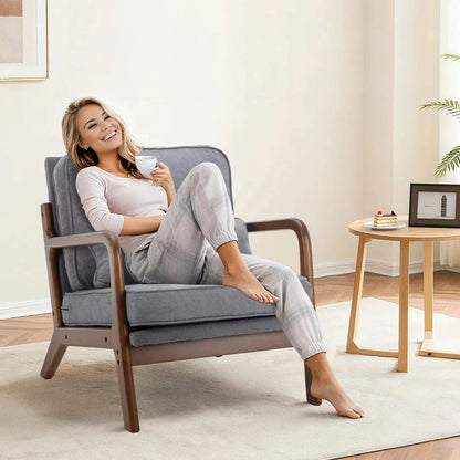 Woman relaxing on a mid century wooden lounge chair with gray cushions in a modern living room