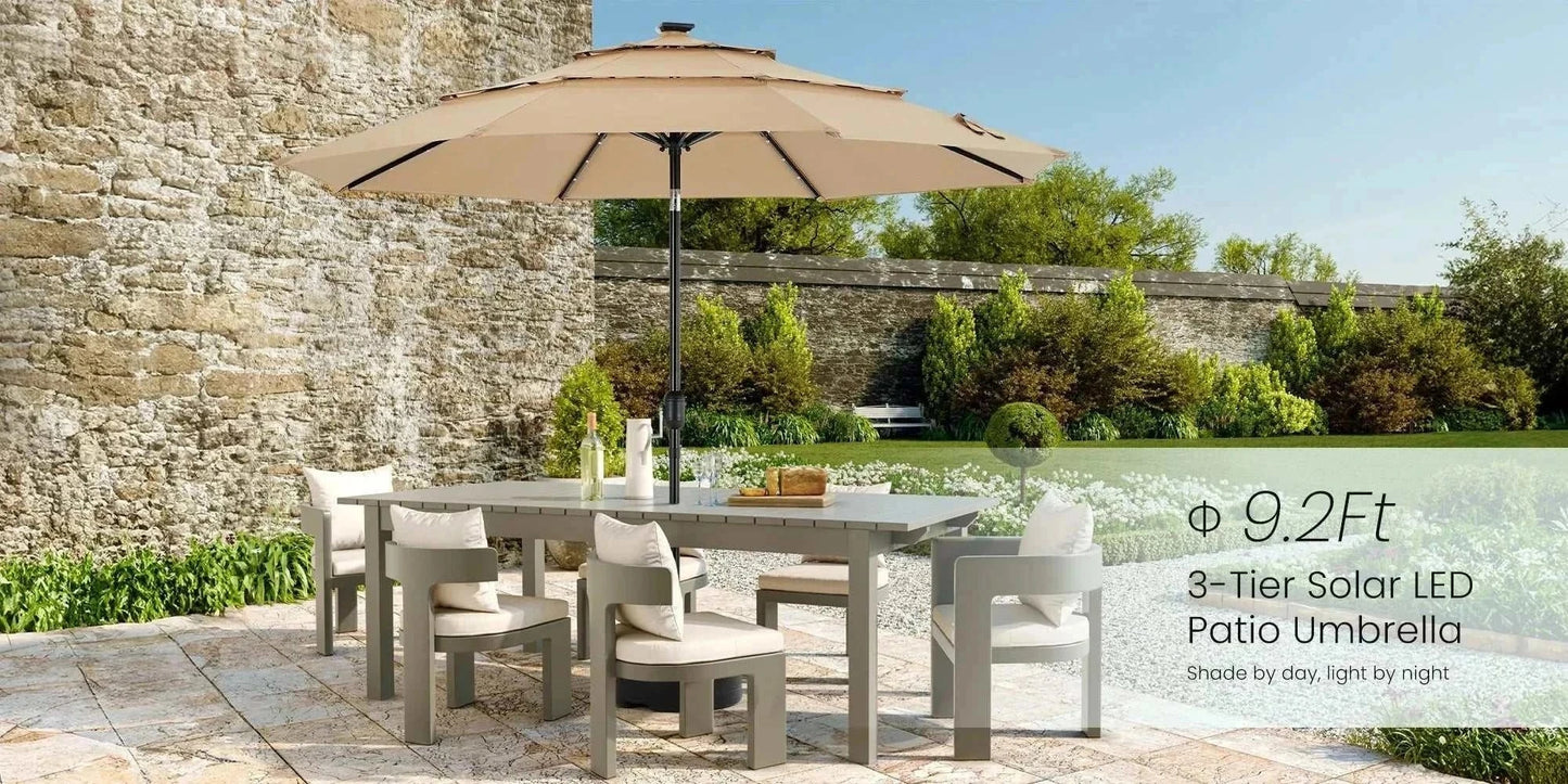 Patio Umbrella Solar Glow with LED in beige over outdoor dining set on patio with stone wall background