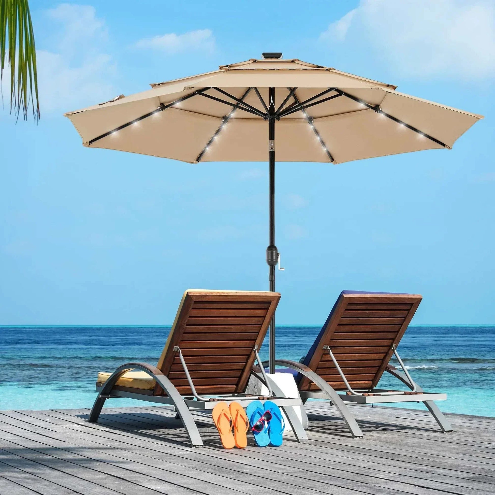 Beige Patio Umbrella Solar Glow with LED lights over two lounge chairs by the ocean