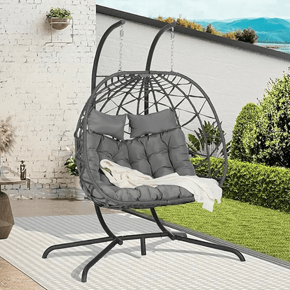 Double Hanging Egg Chair in garden setting, featuring cozy cushions and durable rattan frame for two-person lounging indoors or outdoors.