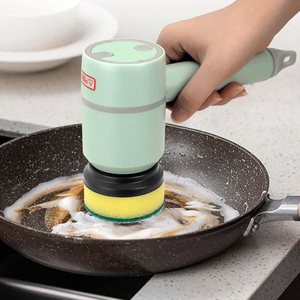 Magic Clean Electric Scrubber cleaning a greasy frying pan with foam detergent, handheld cordless scrub brush with sponge head.