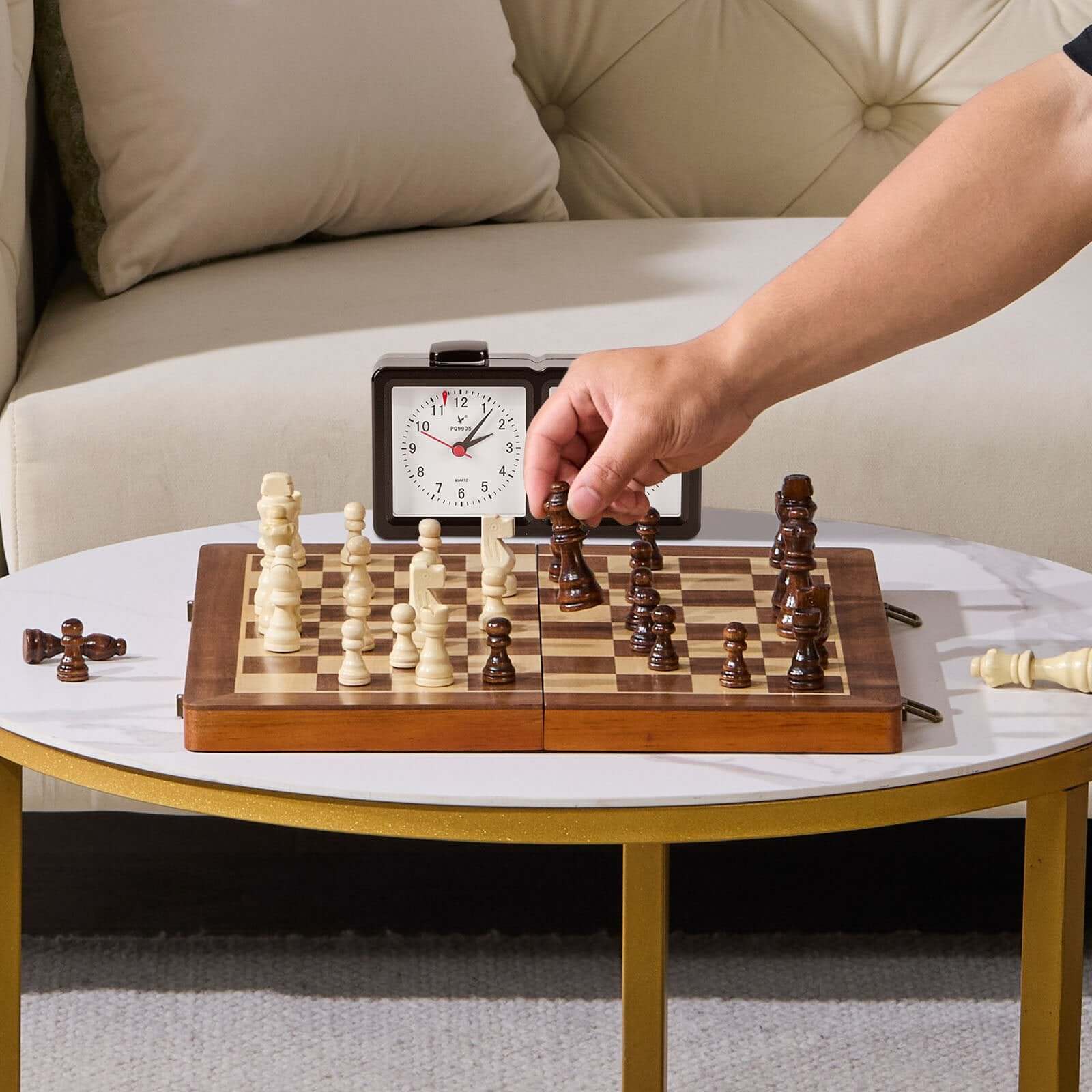 Player moving a chess piece on a Magnetic Chess and Checkers Set during a match with a clock in the background.