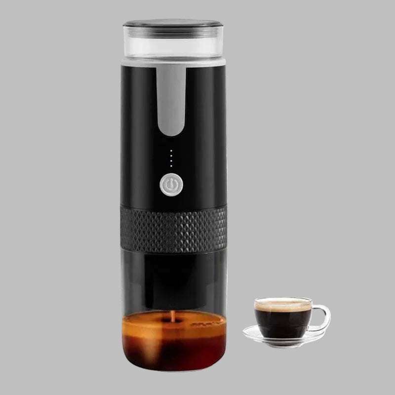Black portable coffee brewer with transparent compartments and power button, shown with a small cup of espresso on gray background
