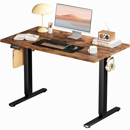 Ergonomic Height Adjustable Table with laptop, lamp, and accessories in a modern office setup