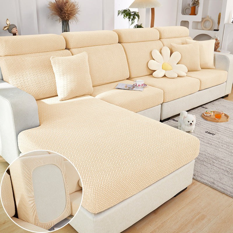 Living room with sofa featuring elastic sofa slipcover in beige, showcasing four-way stretch knit for all-season protection and style.