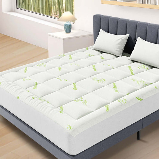 Bamboo mattress protector pad on white bed full view