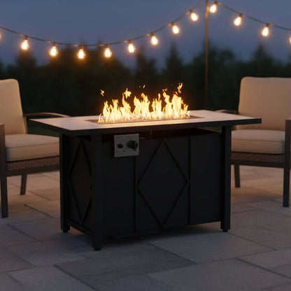 A propane fire pit table with flames, perfect for outdoor gatherings, surrounded by chairs and string lights.