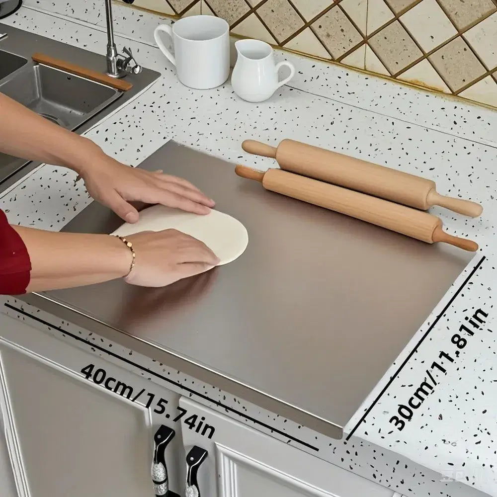 Stainless steel cutting board in use chopping vegetables