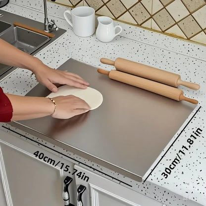 Stainless steel cutting board in use chopping vegetables