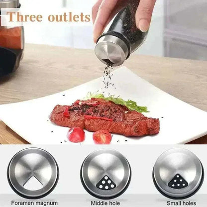 Person using a spice shaker with three outlet options to season a steak on a plate.